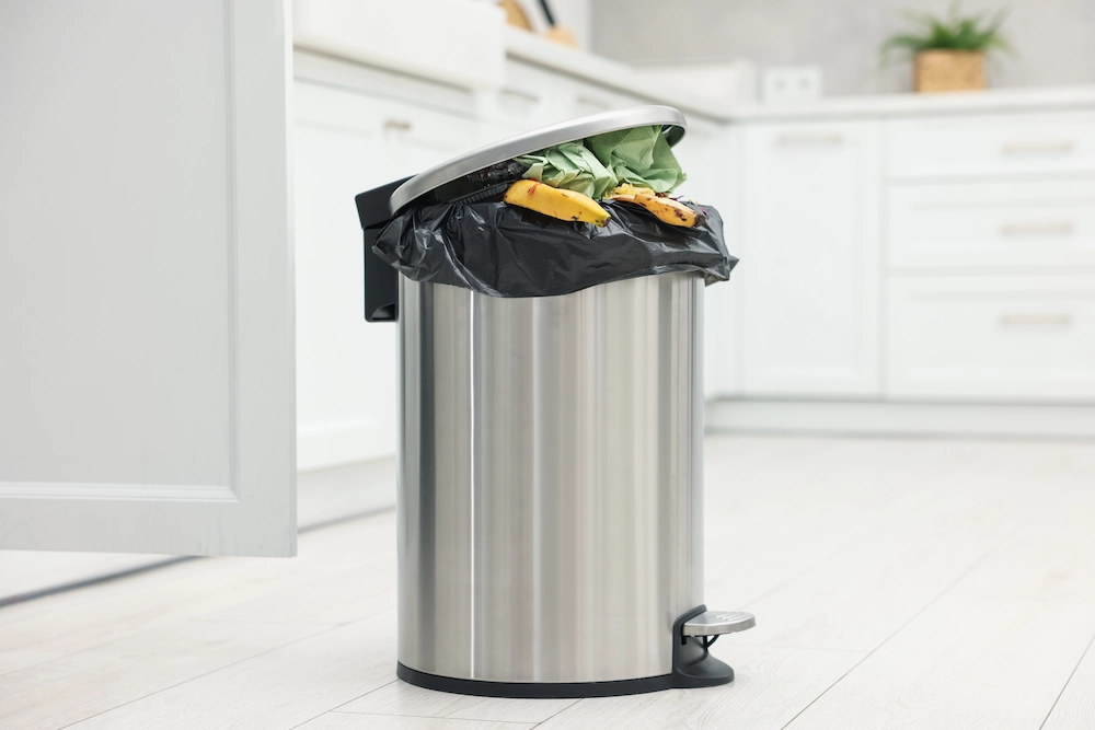 full trash can in kitchen
